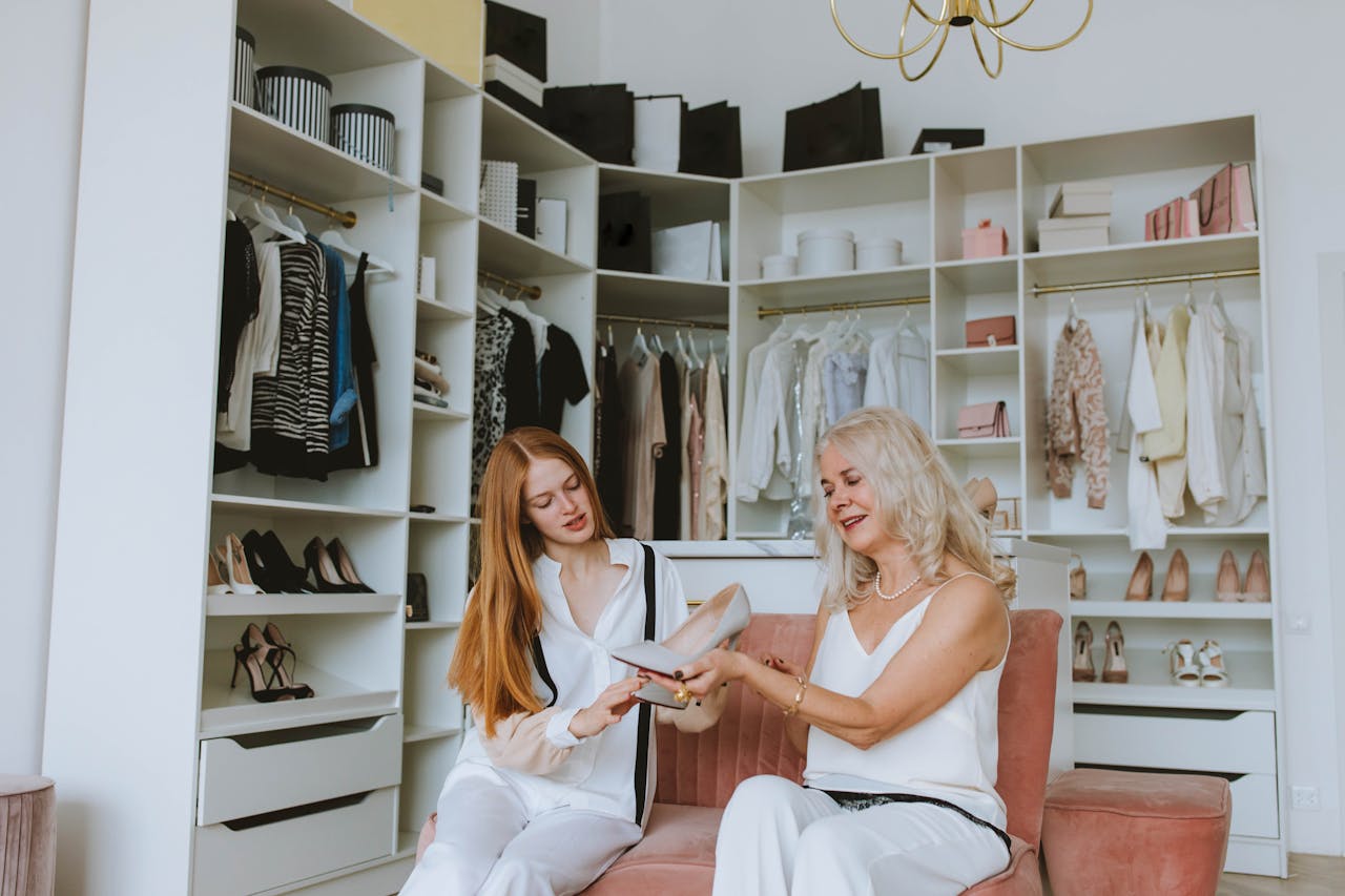 services-bg Two women in a stylish walk-in closet discussing and examining shoes.